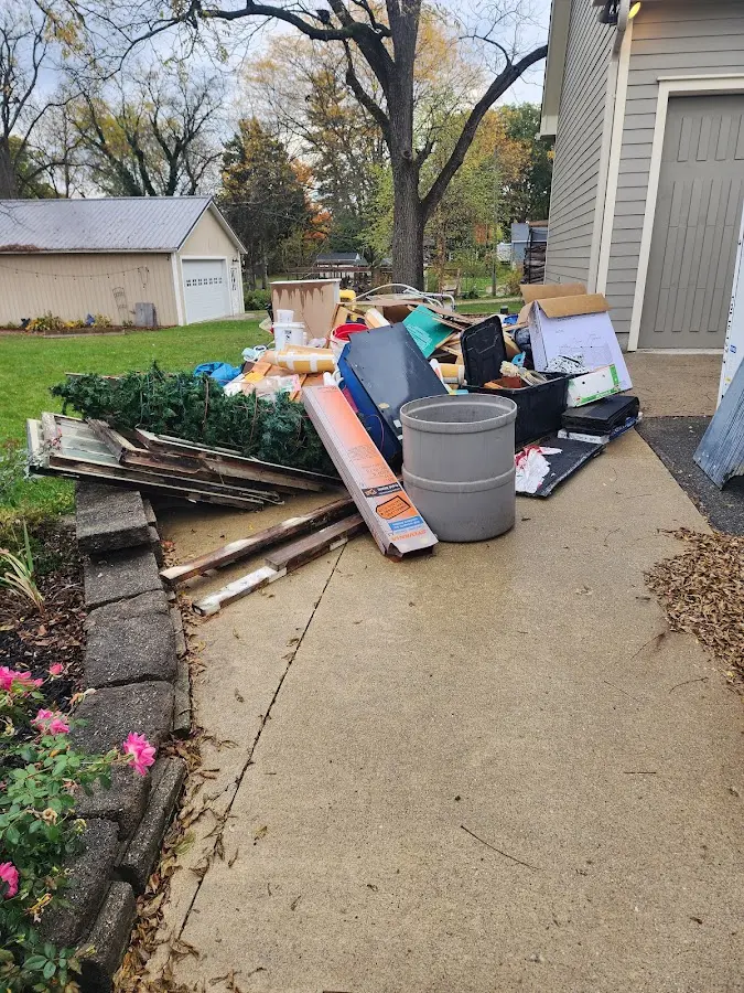 Dumpster being loaded with debris for Commercial Dumpster Rental in North Plainfield